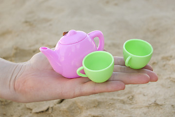 Image showing Toy cups on female hand