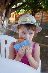 Image showing The little girl eating cake