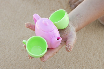 Image showing Toy cups in baby hand