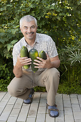 Image showing Satisfied man with three zucchin