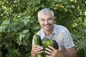 Image showing Satisfied man with three zucchin