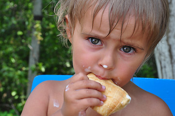 Image showing child eating melting ice-cream