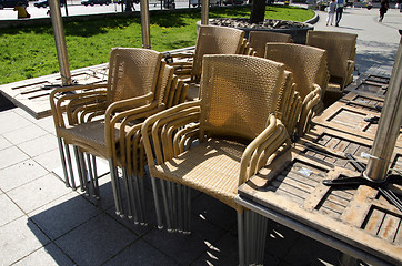 Image showing Wicker chairs and tables on sidewalk 