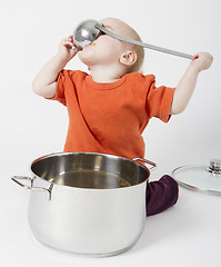 Image showing baby with big cooking pot