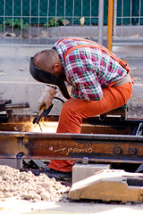 Image showing Construction Worker Fixing Rails