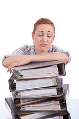 Image showing business woman in office looks at unbelievable folder stack