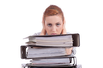 Image showing business woman in office looks at unbelievable folder stack