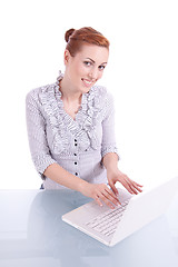Image showing young business woman on computer with snack isolated 