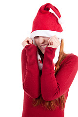 Image showing smiling young woman at christmastime in red clothes isolated