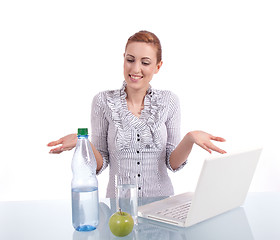 Image showing young business woman on computer with snack isolated 