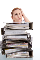 Image showing business woman in office looks at unbelievable folder stack