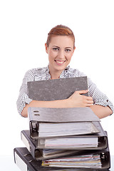 Image showing business woman in office looks at unbelievable folder stack