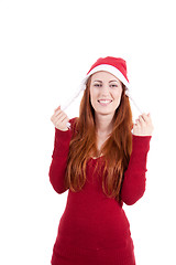 Image showing smiling young woman at christmastime in red clothes isolated