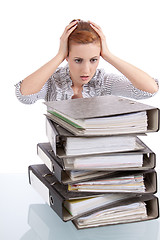 Image showing business woman in office looks at unbelievable folder stack