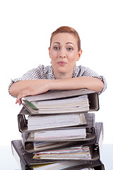 Image showing business woman in office looks at unbelievable folder stack