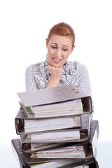 Image showing business woman in office looks at unbelievable folder stack