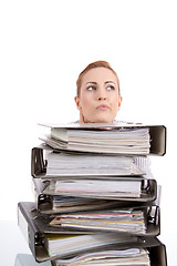 Image showing business woman in office looks at unbelievable folder stack