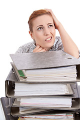 Image showing business woman in office looks at unbelievable folder stack