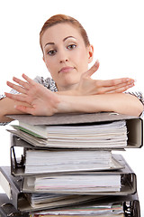 Image showing business woman in office looks at unbelievable folder stack