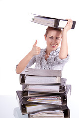 Image showing business woman in office looks at unbelievable folder stack