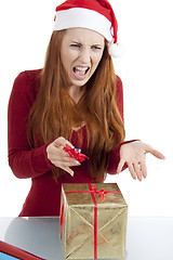 Image showing young woman is packing  present for christmas isolated