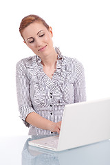 Image showing young business woman on computer with snack isolated 