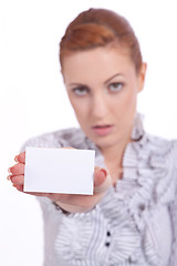 Image showing beautiful young girl is holding a blank card in hand isolated