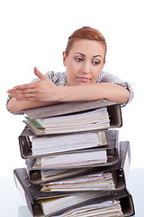 Image showing business woman in office looks at unbelievable folder stack