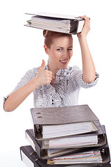 Image showing business woman in office looks at unbelievable folder stack