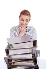 Image showing business woman in office looks at unbelievable folder stack