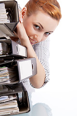 Image showing business woman in office looks at unbelievable folder stack