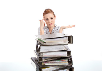 Image showing business woman in office looks at unbelievable folder stack