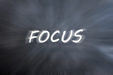 Image showing Focus word with motion rays on retro blackboard background 