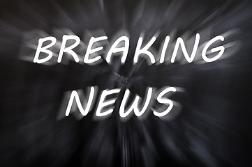 Image showing Breaking news written with motion rays on retro blackboard background 