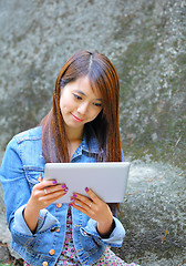 Image showing young asian woman with tablet computer outdoor