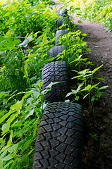Image showing Forest path strengthen with old used car tires 