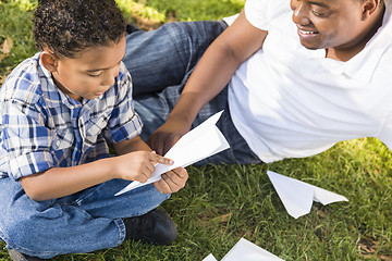 Image showing Mixed Race Father and Son Playing with Paper Airplanes