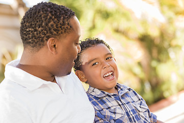 Image showing Happy Mixed Race Father and Son Talking