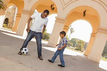 Image showing Mixed Race Father and Son Playing Soccer in the Courtyard