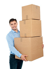 Image showing Happy young man carrying heavy packages