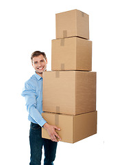 Image showing Handsome male with with stack of boxes