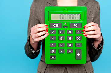 Image showing Hands of a businesswoman showing calculator