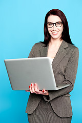Image showing Young corporate woman working on laptop