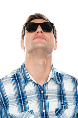 Image showing Casual young man looking upwards