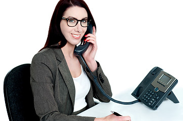 Image showing Young businesswoman holding phone receiver