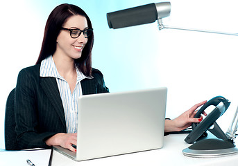 Image showing Female secretary answering phone call