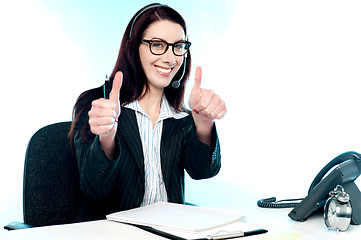 Image showing Call centre operator gesturing double thumbs up