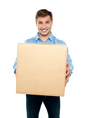 Image showing Charming handsome male holding carton
