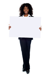 Image showing Corporate woman displaying white ad board