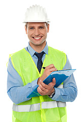 Image showing Construction engineer writing on notepad